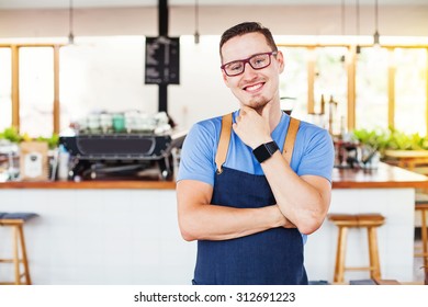 handsome restaurant owner standing in front of the coffee bar