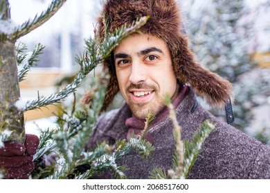 Handsome Russian Man Shopping For Christmas Tree Outdoors Market