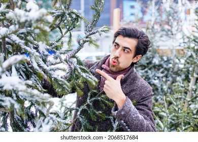 Handsome Russian Man Shopping For Christmas Tree Outdoors Market