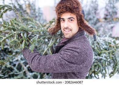 Handsome Russian Man Shopping For Christmas Tree Outdoors Market