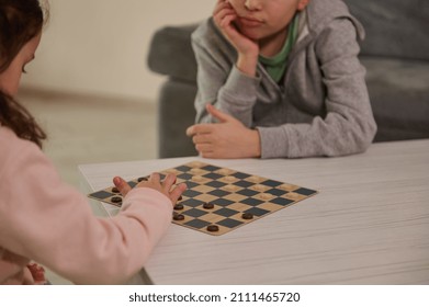 Handsome School Aged Kids Playing Checkers Table Game, Staying At Home Quarantine Concept. Board Game And Kids Leisure Concept. Family Time.