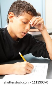 Handsome School Boy Struggling To Finish A Test In Class.