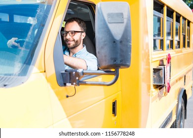 Handsome School Bus Driver Smiling And Driving