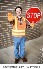 Handsome School Crossing Guard Holding A Stop Sign.  