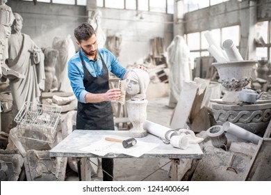 Handsome Sculptor Brushing Stone Head Sculpture On The Table In The Atmospheric Studio