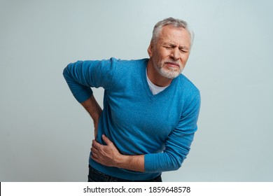 Handsome senior  isolated on grey background. Old man feeling pain. Concept about the third age and seniority - Shutterstock ID 1859648578