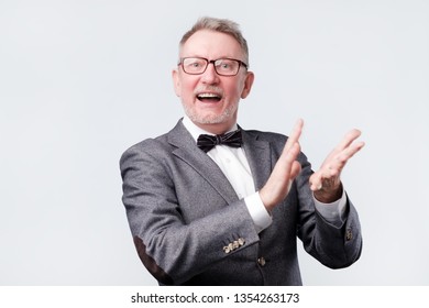 Handsome Senior Man In Glasses And Suit Applauding