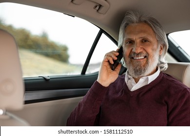 Handsome Senior Man Is Talking On The Phone In The Car