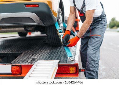 Handsome senior man working in towing service on the road. Roadside assistance concept. - Shutterstock ID 1864264486