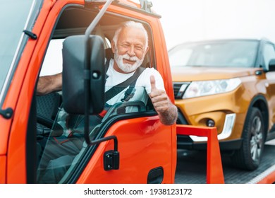 Handsome Senior Man Working In Towing Service On The Road. Roadside Assistance Concept.