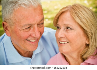 Handsome seniors in park having intimate moments - Powered by Shutterstock