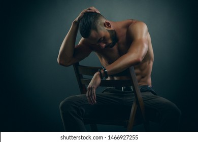 Handsome Shirtless Male Fashion Model Sitting On A Chair