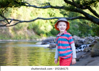 handsome smiling boy standing by the river