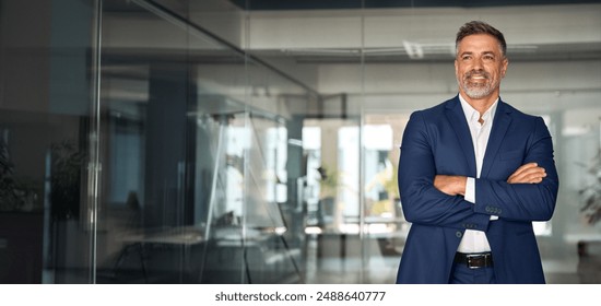 Handsome smiling confident hispanic senior man with crossed arms looking aside. Indian or latin successful mature middle age leader male businessman, business investor in office. Banner, copy space. - Powered by Shutterstock