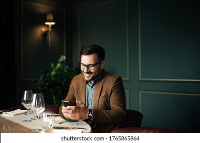 Handsome Smiling Man Using Smart Phone At Restaurant, Portrait, Copy Space.