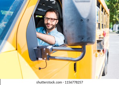handsome smiling school bus driver looking at camera