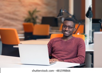 Handsome Smiling Successful African American Man Wearing Formal Suit, Oval Glasses, Using Laptop Computer For Distant Work