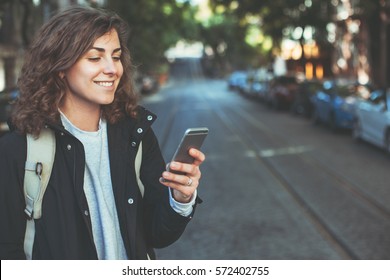 Handsome Smiling Woman With Mobile Phone Walking On The Street