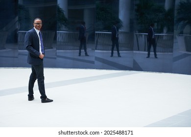 Handsome Smiling Young Businessman Standing Outside Office Building, Turning Back And Looking At Camera