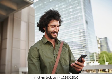 Handsome smiling young man in formal clothing using smartphone - Powered by Shutterstock