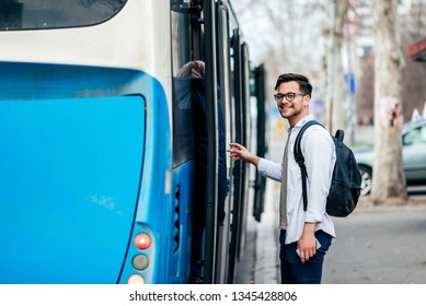 Handsome Smiling Young Man Getting Into Bus.