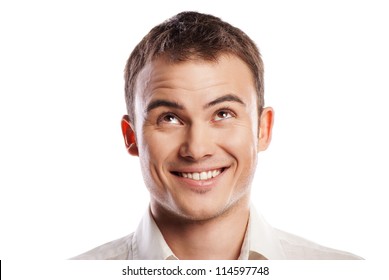 Handsome smiling young man looking up over white background
