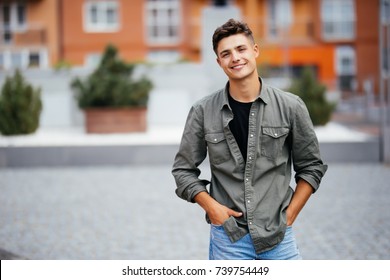 Handsome smiling young man portrait. Cheerful men looking at camera