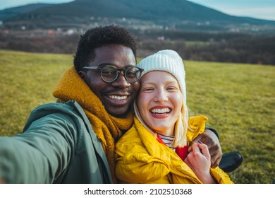 Handsome smilling happy couple friends hiker taking a photo selfie. Close up shot of two young cheerful lovers in the summer nice wood, embracing, posing for a selfie shot - Shutterstock ID 2102510368