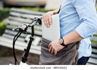 Handsome Sportive Man Taking Out Laptop From The Bag.