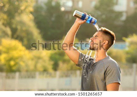 Similar – Image, Stock Photo Young athlete refreshes himself with water after a hard workout on the athletic oval in the intense heat. Endurance training. Brown-haired adolescent