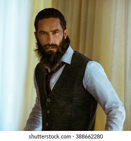 Handsome Strong, Brutal Bearded Man Posing In Suit