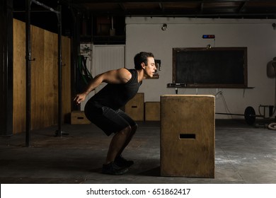 Handsome Strong Hispanic Man About To Jump Onto A Box In A Cross-training Gym