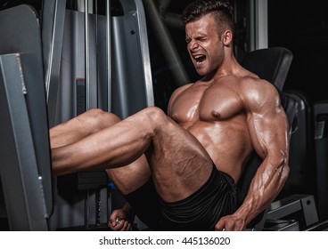 Handsome Strong Man Performed Leg Press In The Gym.