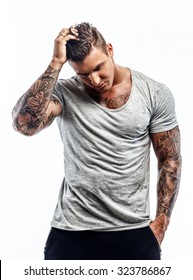 Handsome Strong Tattooed Man In Grey T Shirt Isolated On White Background.