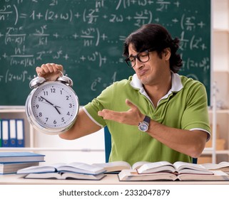Handsome student in front of chalkboard with formulas