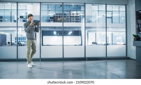 Handsome Stylish Interior Designer Standing In Empty Modern Office And Map It With An Augmented Reality Software On A Tablet Computer. Architect Planning Out The Floor For Business Company Space.