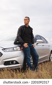 Handsome Stylish Man Standing Near His Car At The Field