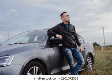 Handsome Stylish Man Standing Near His Car At The Field