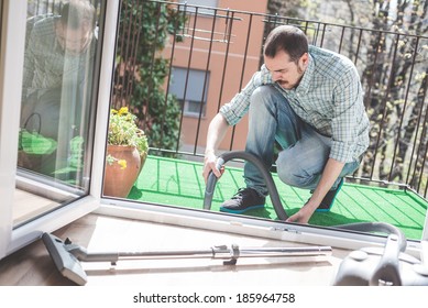 Handsome Stylish Man Using Hoover At Home