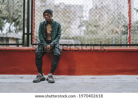 Similar – Black young man listening to music in a sunny day