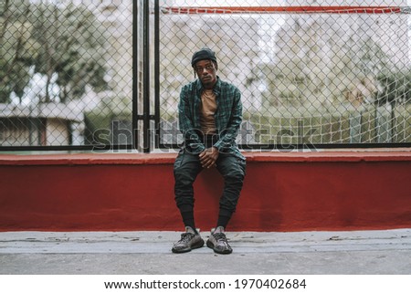 Similar – Black young man listening to music in a sunny day