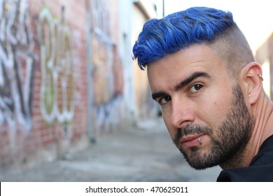 Handsome Stylish Young Man With Artificially Colored Blue Dyed Hair Undercut Hairstyle, Beard And Piercings With Copy Space