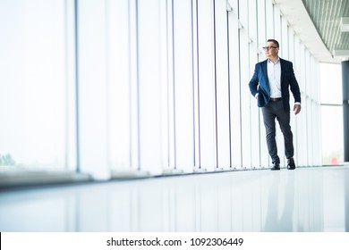 Handsome And Sucessful Senior Business Man Walking In Modern Office