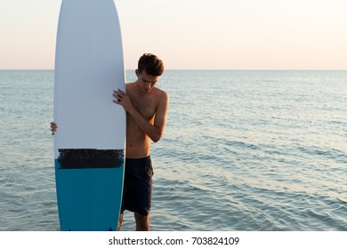 Handsome Surfer Holding His Surfboard