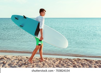 Handsome Surfer Holding His Surfboard