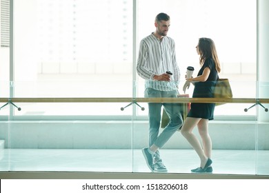 Handsome Tall Young Man Drinking Coffee And Talking To Girlfriend After Shopping In Mall