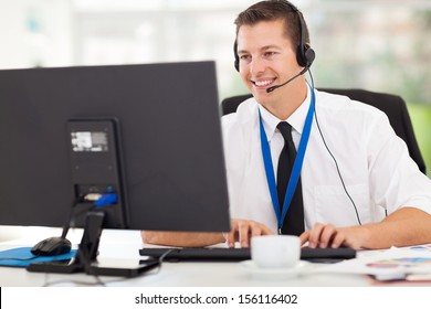 handsome technical support operator working on computer