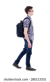 handsome teenage boy with backpack walking isolated on white background