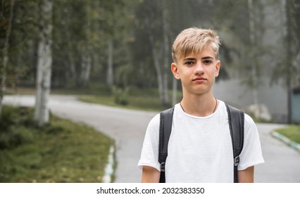 Handsome Teenager 15-18 Years Old Male High School Student.  Smiling Teenage Boy With School Bag On The Way To  College. Close Up Emotional Portrait Of Caucasian Young Man