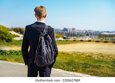 Handsome Teenager 15-18 Years Old Male High School Student. Smiling Teenage Boy With School Bag On The Way To College. High Quality Photo